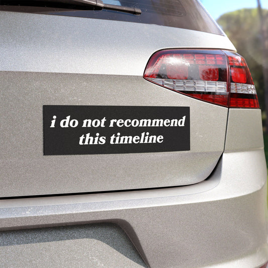 The rear of a silver hatchback showcases the Timeline Sticker & Magnet on its black bumper, humorously stating i do not recommend this timeline in white, reflecting mental health themes.