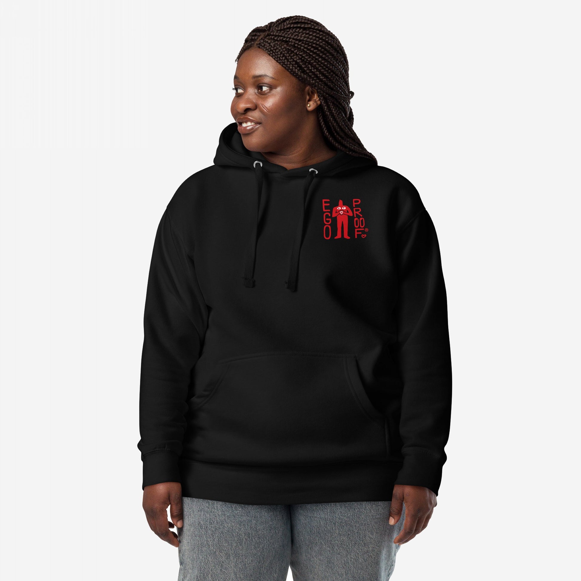 Person in a black 99 Problems Hoodie EU with “EGO PROOF” chest graphic, featuring a bold back print about anxiety. They wear light-wash jeans, embodying casual resilience and mental health awareness.