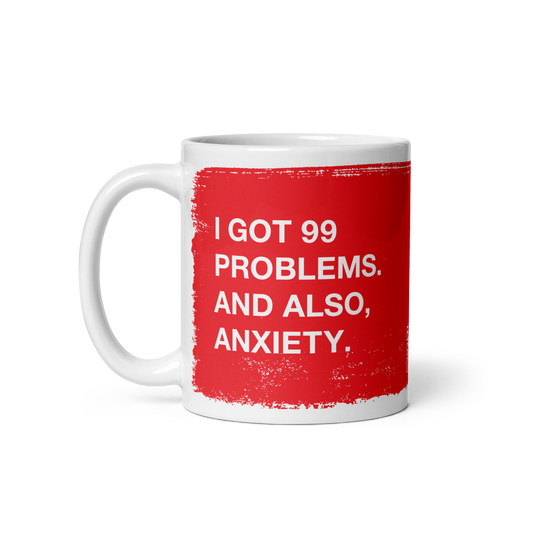 White ceramic 99 Problems Mug with red text stating "I got 99 problems. And also, anxiety." on both sides.