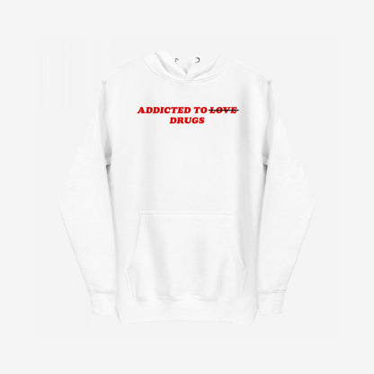 White hoodie with ADDICTED TO LOVE slogan, with LOVE crossed out, and DRUGS. beneath. Titled Addicted To Love / Drugs Hoodie EU, it symbolizes humor, rebellion, and emotional resilience.