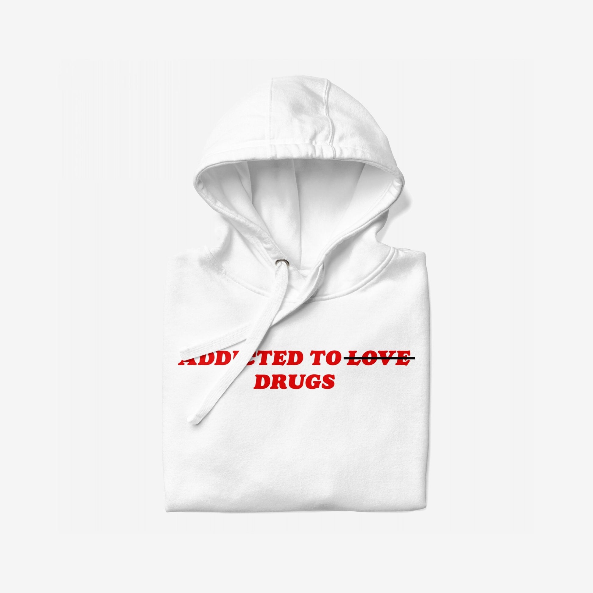 Folded white hoodie titled Addicted To Love / Drugs Hoodie EU features bold red text, ADDICTED TO LOVE, with TO LOVE crossed out and DRUGS beneath. Ideal for self-care or gifting.