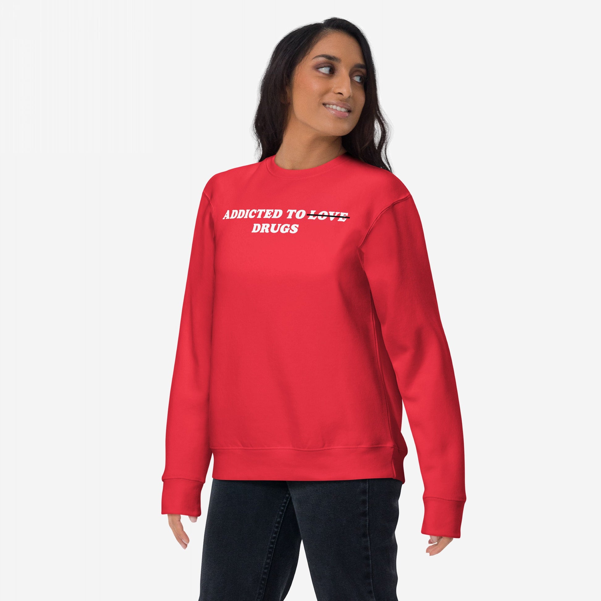 Young woman in a red Addicted To Love / Drugs Sweatshirt EU featuring bold white lettering, expressing dark humor and candor, ideal for mental health awareness and self-expression.