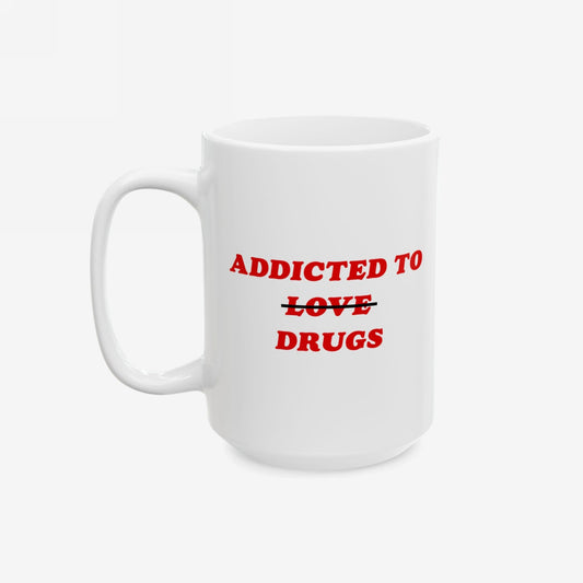 Plain white ceramic mug with bold red text: ADDICTED TO ~~LOVE~~ DRUGS. The word LOVE is crossed out, replaced by DRUGS. Perfect for a humorous take on mental health themes.