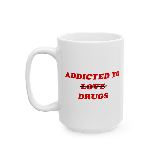 Plain white ceramic mug with bold red text: ADDICTED TO ~~LOVE~~ DRUGS. The word LOVE is crossed out, replaced by DRUGS. Perf