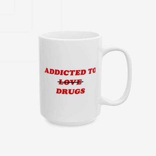 White ceramic mug with the slogan Addicted To Love / Drugs in bold red letters, featuring LOVE crossed out. A humorous, mental health-themed item from Egoproof, ideal for coffee and contemplation.