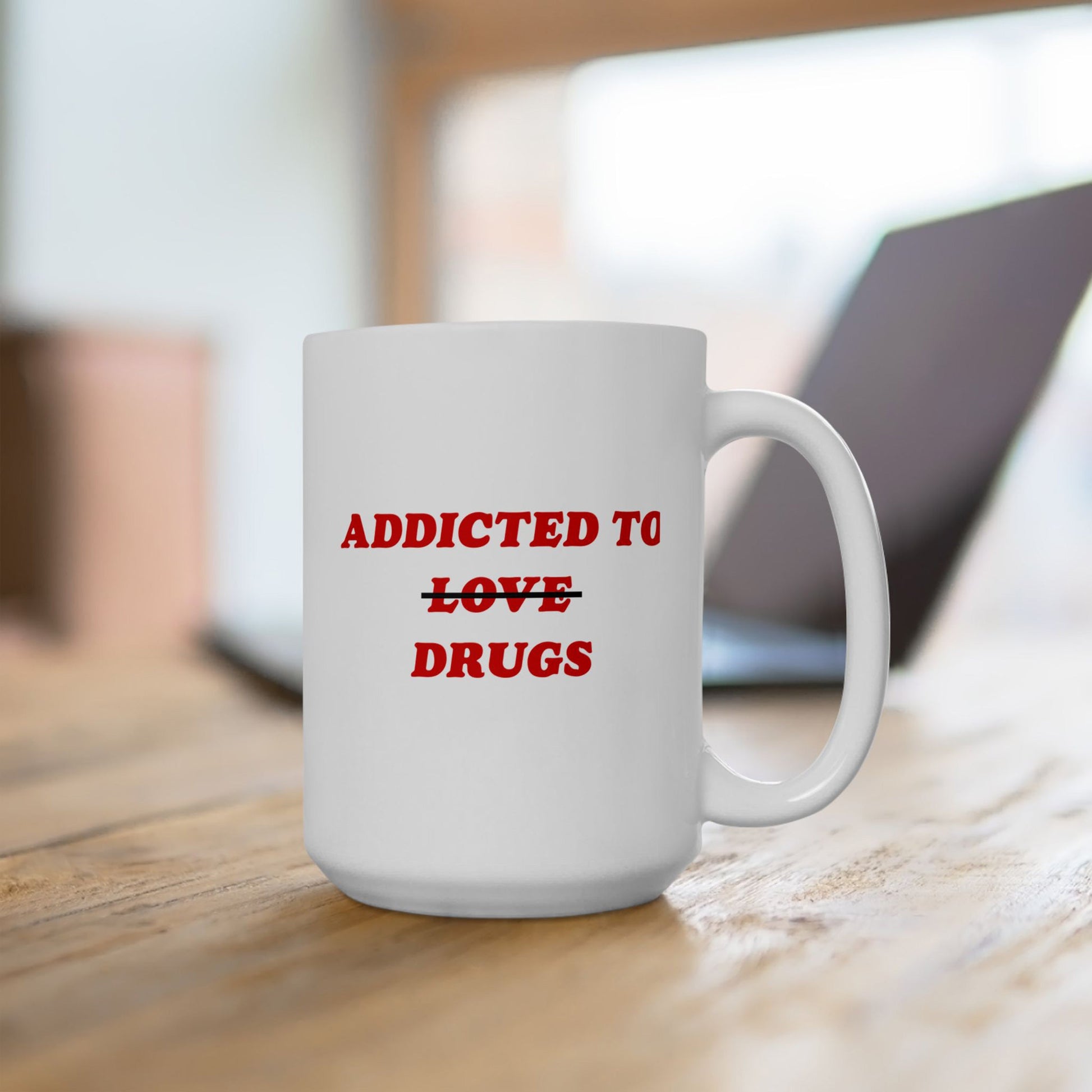 White ceramic mug with ADDICTED TO ~~LOVE~~ DRUGS in red text, capturing Egoproof's edgy humor. It's designed for those embracing mental health journeys with wit.