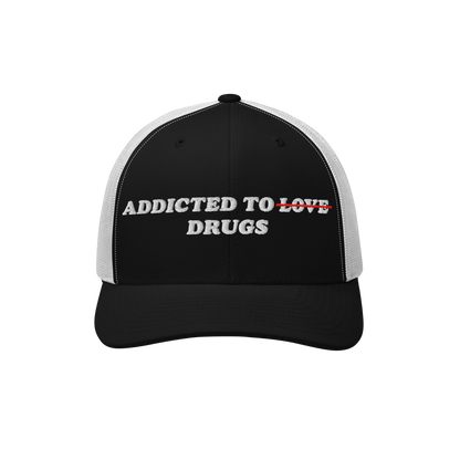 The Egoproof Addicted To Love / Drugs Hat is a striking black and white cap with LOVE crossed out in red and replaced by DRUG