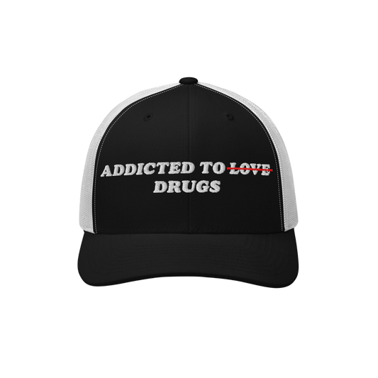 The Egoproof Addicted To Love / Drugs Hat is a striking black and white cap with LOVE crossed out in red and replaced by DRUG