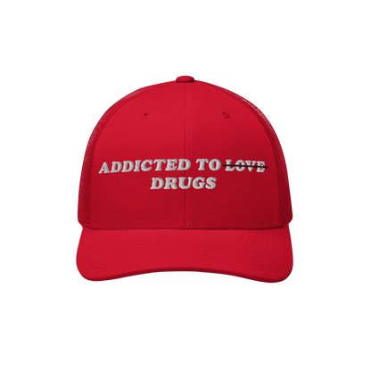 The Egoproof Addicted To Love / Drugs Hat is a red embroidered snapback with “ADDICTED TO ~LOVE~ DRUGS”—LOVE struck thr