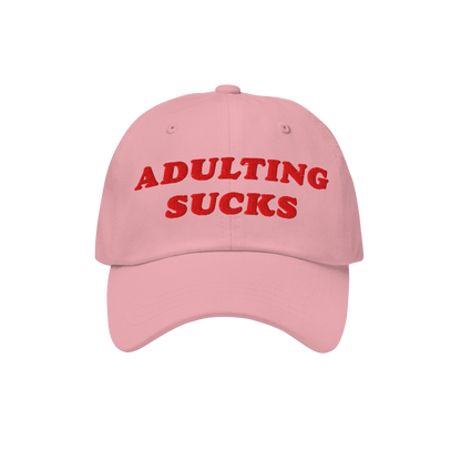 Light pink cap with bold red embroidery stating ADULTING SUCKS on the front, reflecting Egoproof's ethos. A vintage-inspired,