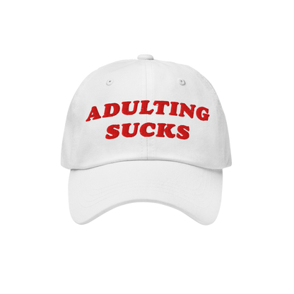 The Adulting Sucks Hat features bold red embroidery stating ADULTING SUCKS on a white baseball-style cap, embodying a vintage