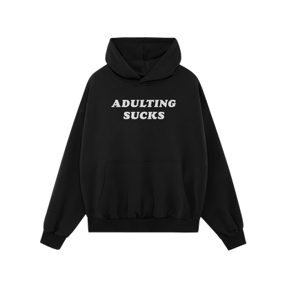 Black "Adulting Sucks Hoodie" with white bold text, midweight and comfortable, perfect for casual wear and expressing relatab