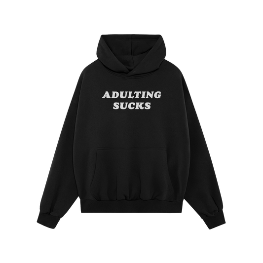 Black "Adulting Sucks Hoodie" with white bold text, midweight and comfortable, perfect for casual wear and expressing relatab