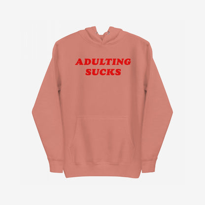 Adulting Sucks Hoodie EU features bold red ADULTING SUCKS text, kangaroo pocket, and drawstring hood, embodying Egoproof's ethos of tackling mental health struggles with comfort and humor.