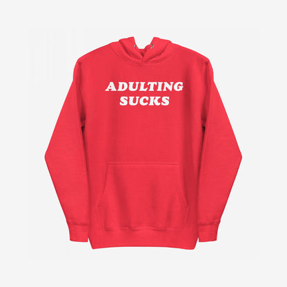 Adulting Sucks Hoodie EU features a bold “ADULTING SUCKS.” statement on a comfy red pullover with a kangaroo pocket, embodying humor and resilience for navigating life’s challenges.