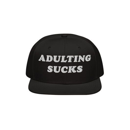 Adulting Sucks Hat featuring a black, flat-brimmed snapback design with “ADULTING SUCKS” embroidered in white. Perfect fo