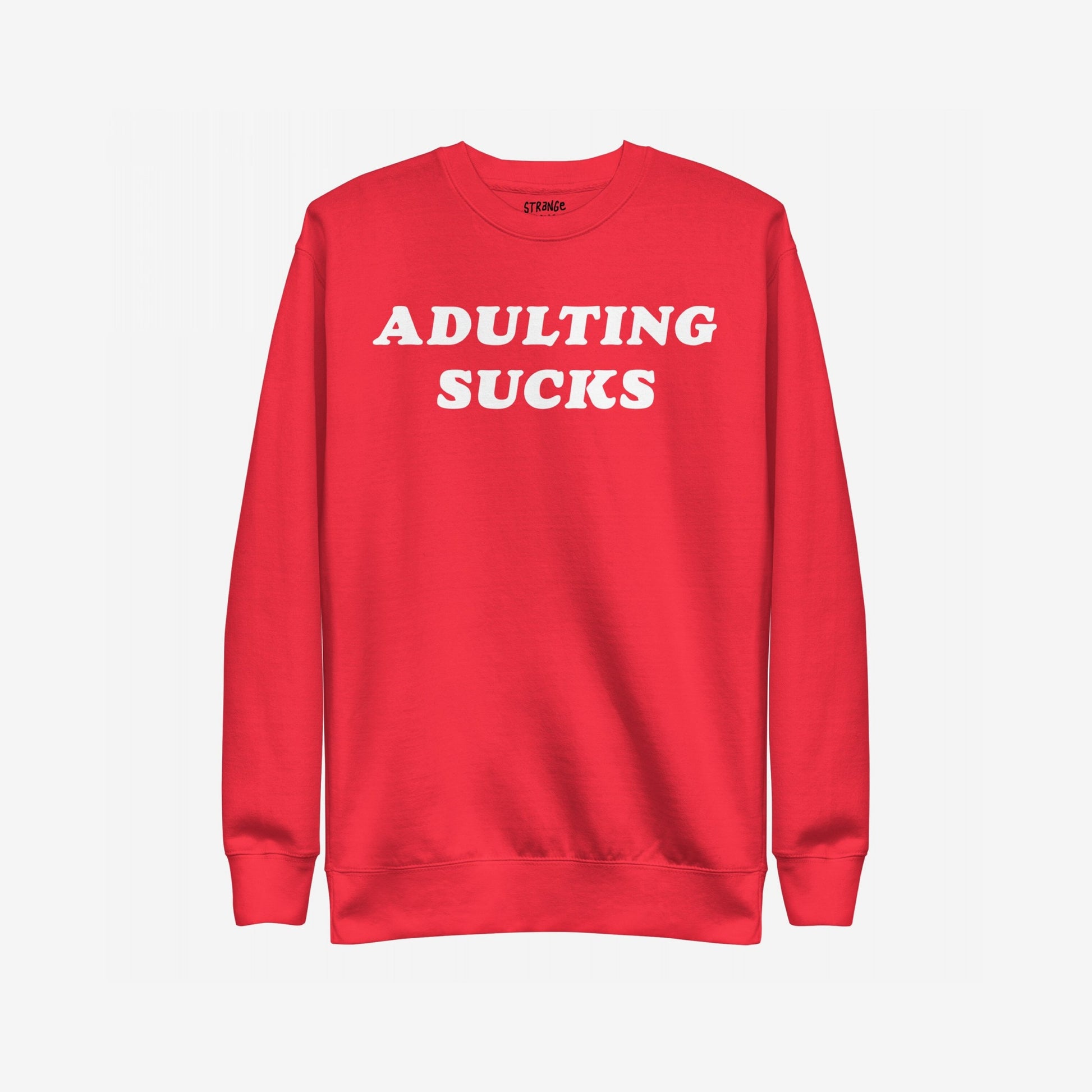 Adulting Sucks Sweatshirt EU: A red crewneck sweatshirt featuring bold white “ADULTING SUCKS” text, perfect for expressing the struggles of everyday life with humor and style.