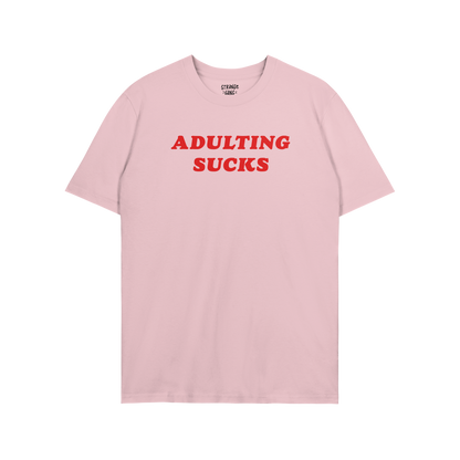 Adulting Sucks T-shirt in light pink with bold red text, unisex casual tee perfect for laid-back, sarcastic style and lazy da
