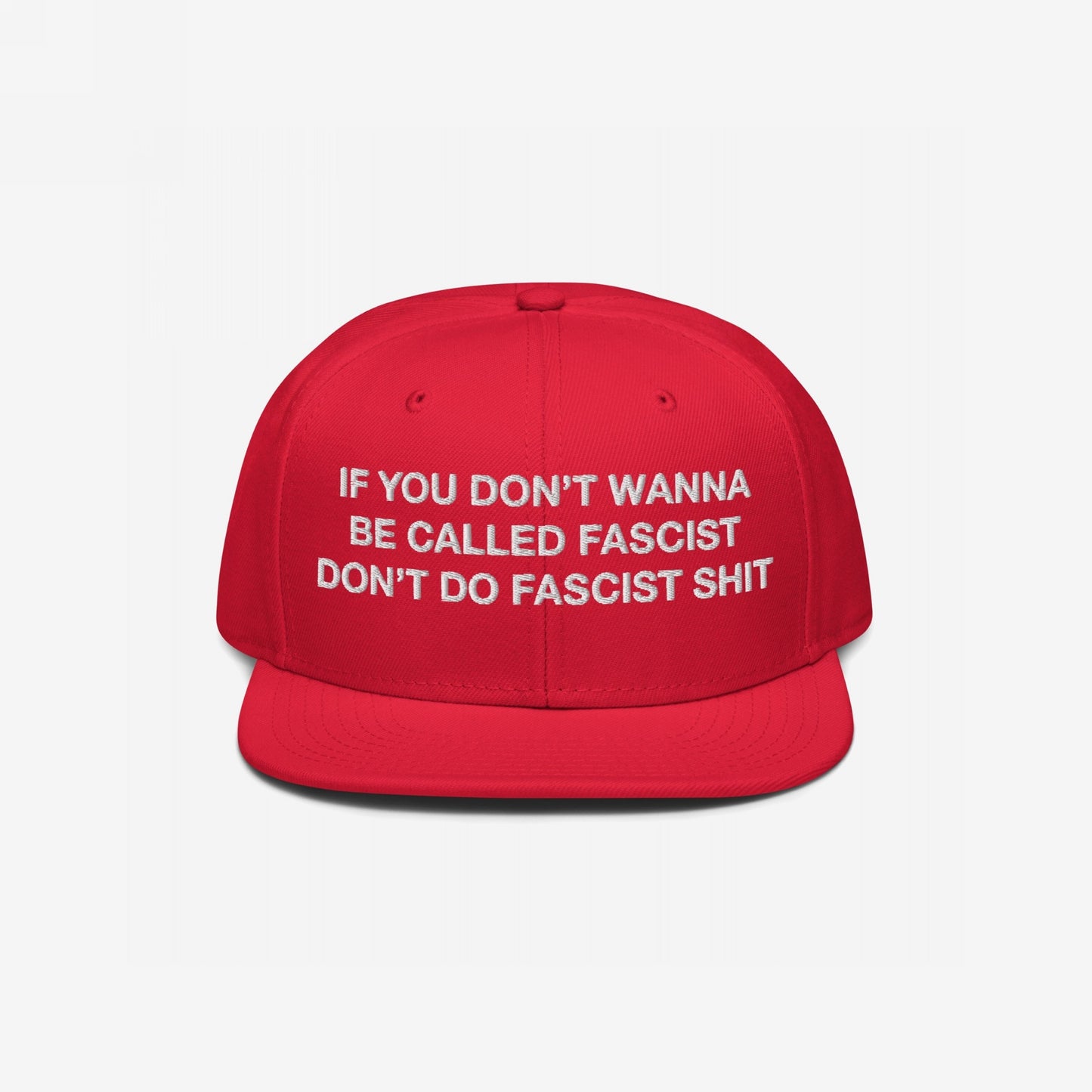 Anti-Fascist Hat featuring bold white embroidered text, If you don’t wanna be called fascist, don’t do fascist shit, on a bright red flat-bill cap, embodies resistance and everyday activism.