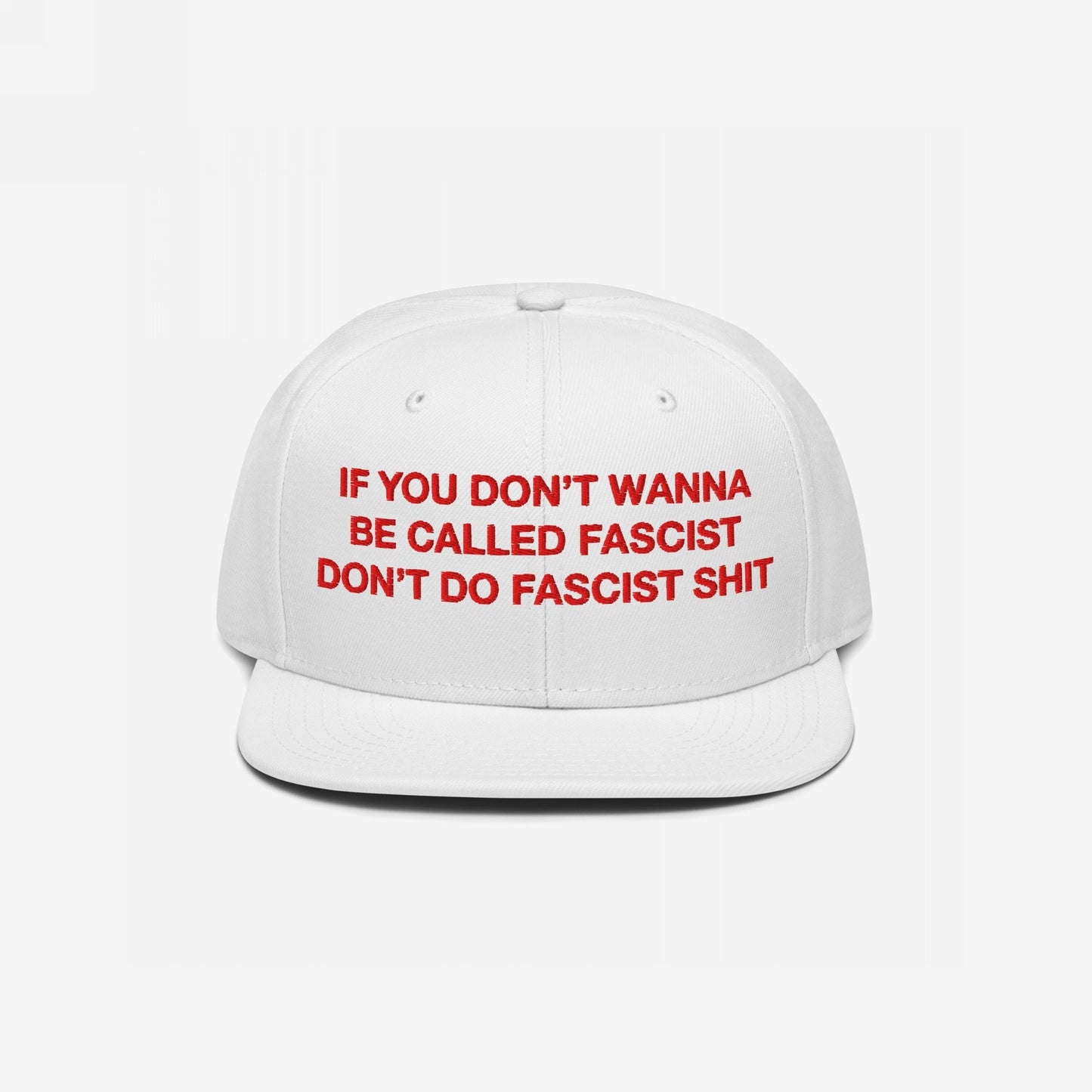 Anti-Fascist Hat with bold red embroidery on a white, flat-brim cap, stating IF YOU DON’T WANNA BE CALLED FASCIST DON’T DO FASCIST SHIT, embodying everyday resistance against hate.