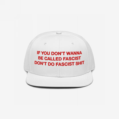 Anti-Fascist Hat with bold red embroidery on a white, flat-brim cap, stating IF YOU DON’T WANNA BE CALLED FASCIST DON’T DO FASCIST SHIT, embodying everyday resistance against hate.
