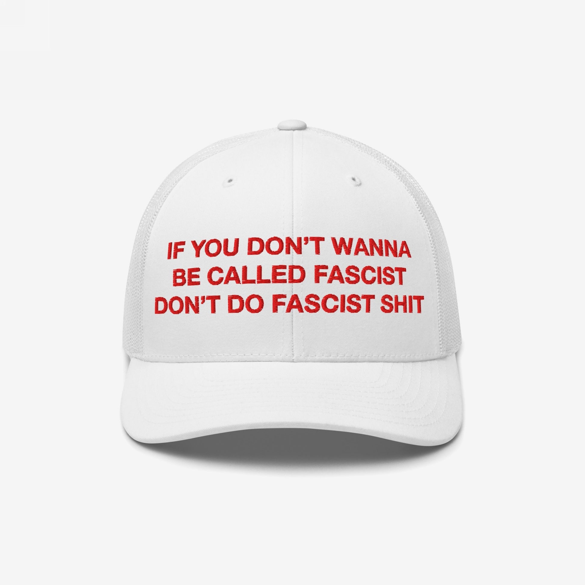 Anti-Fascist Hat featuring bold red embroidery of the slogan, If you don’t wanna be called fascist, don’t do fascist shit, on a trucker-style cap with a white mesh back.