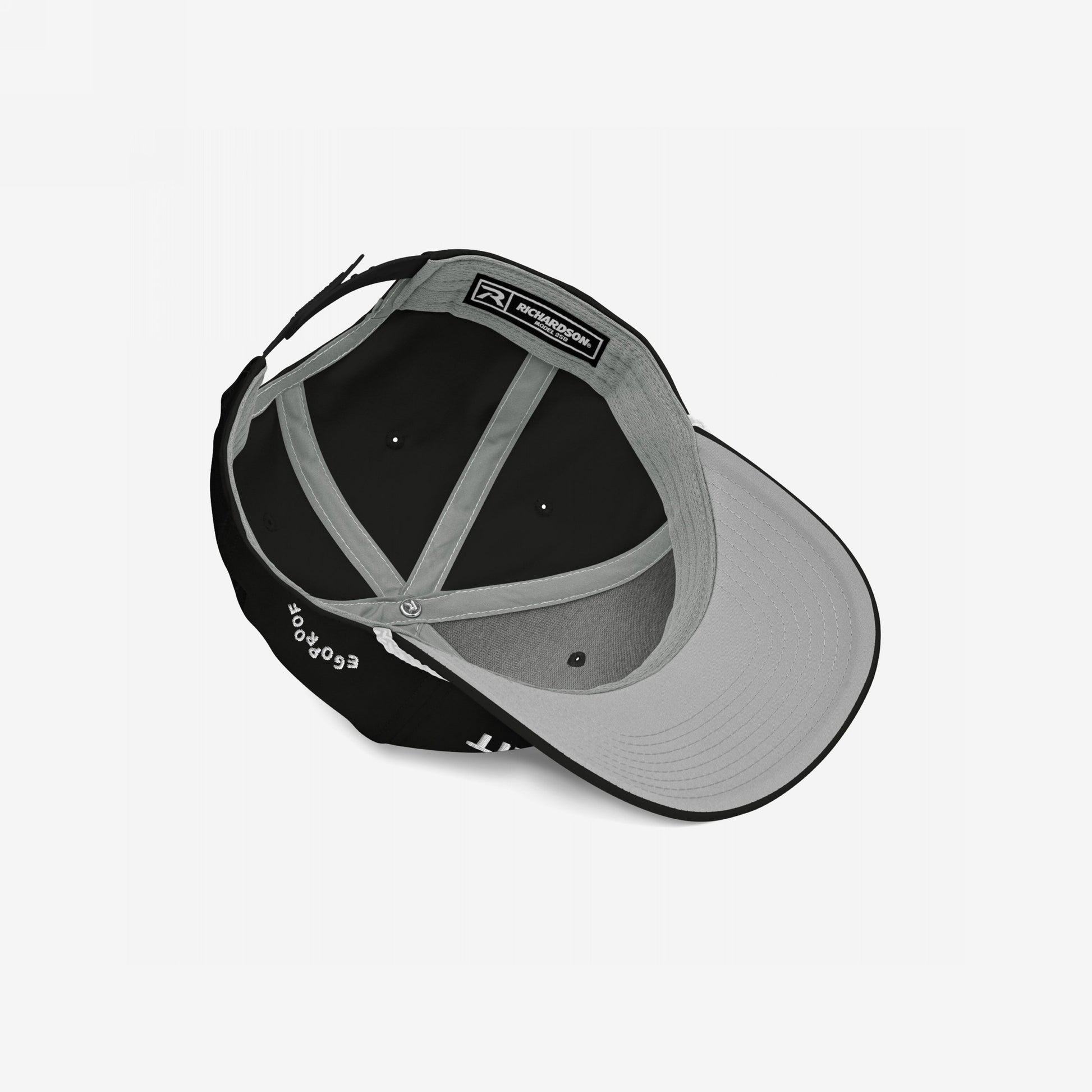 Anti-Racist Hat displayed inside-out, revealing the interior panels, Richardson sweatband label, and gray bill underside. Bold embroidery and powerful message embody Egoproof's commitment to impactful, statement-making apparel.