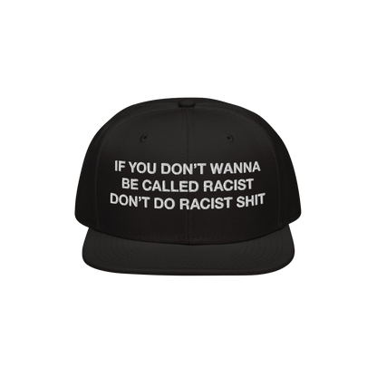 Anti-Racist Hat EU features bold white embroidery on a black flat-brim cap, stating, “IF YOU DON’T WANNA BE CALLED RACIST