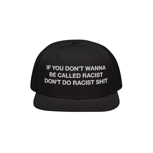 Anti-Racist Hat EU features bold white embroidery on a black flat-brim cap, stating, “IF YOU DON’T WANNA BE CALLED RACIST