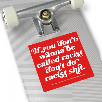 Close-up of the Anti-Racist Sticker & Magnet on a skateboard's underside, featuring bold text If you don’t wanna be called racist don’t do racist shit, conveying a strong, clear message.
