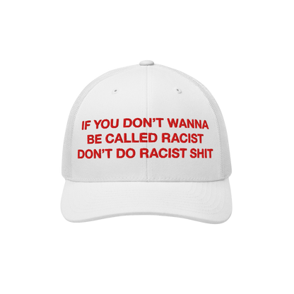 White trucker-style baseball cap with red text reading “If you don’t wanna be called racist don’t do racist shit.”, e