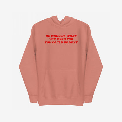 Be Careful Hoodie EU featuring a bold red slogan warning across the chest, with kangaroo pocket, ribbed cuffs, and drawstring hood. Designed for activism and everyday rebellion.