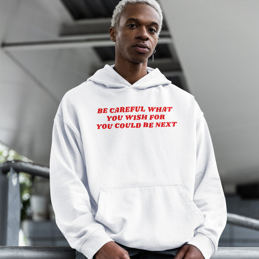 Young man wearing a white Be Careful Hoodie with red text warning about social justice and activism.