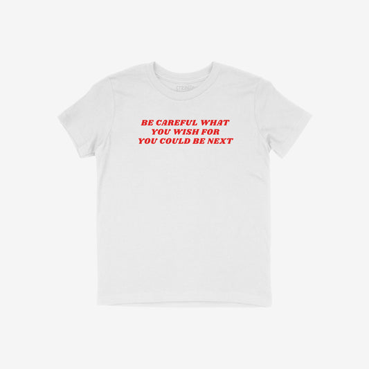 White Be Careful Kids T-shirt with bold red text "Be Careful What You Wish For You Could Be Next" in unisex fit.