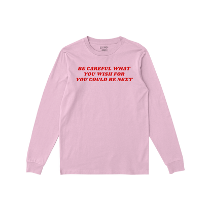 Pink long sleeve Be Careful T-shirt with bold red text warning to be careful what you wish for, promoting awareness and resis