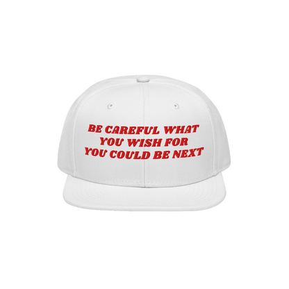 The Be Careful Hat features bold red embroidery reading, BE CAREFUL WHAT YOU WISH FOR YOU COULD BE NEXT, on a white snapback,