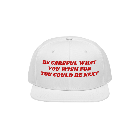 The Be Careful Hat features bold red embroidery reading, BE CAREFUL WHAT YOU WISH FOR YOU COULD BE NEXT, on a white snapback,