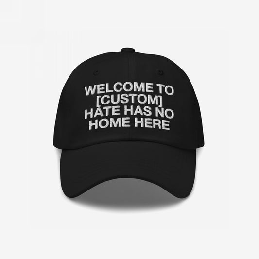 Custom Hate Has No Home Here Dad Hat in black with bold embroidered message promoting love and inclusion on a classic adjustable fit cap.