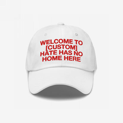 White Custom Hate Has No Home Here Dad Hat with red embroidered bold text promoting love and inclusivity, adjustable strap and classic fit.
