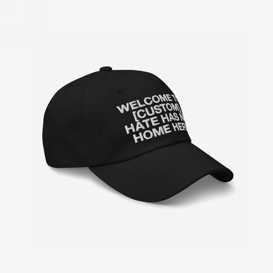 Black adjustable Custom Hate Has No Home Here Dad Hat with bold white embroidered anti-hate message and low-profile chino cotton design.