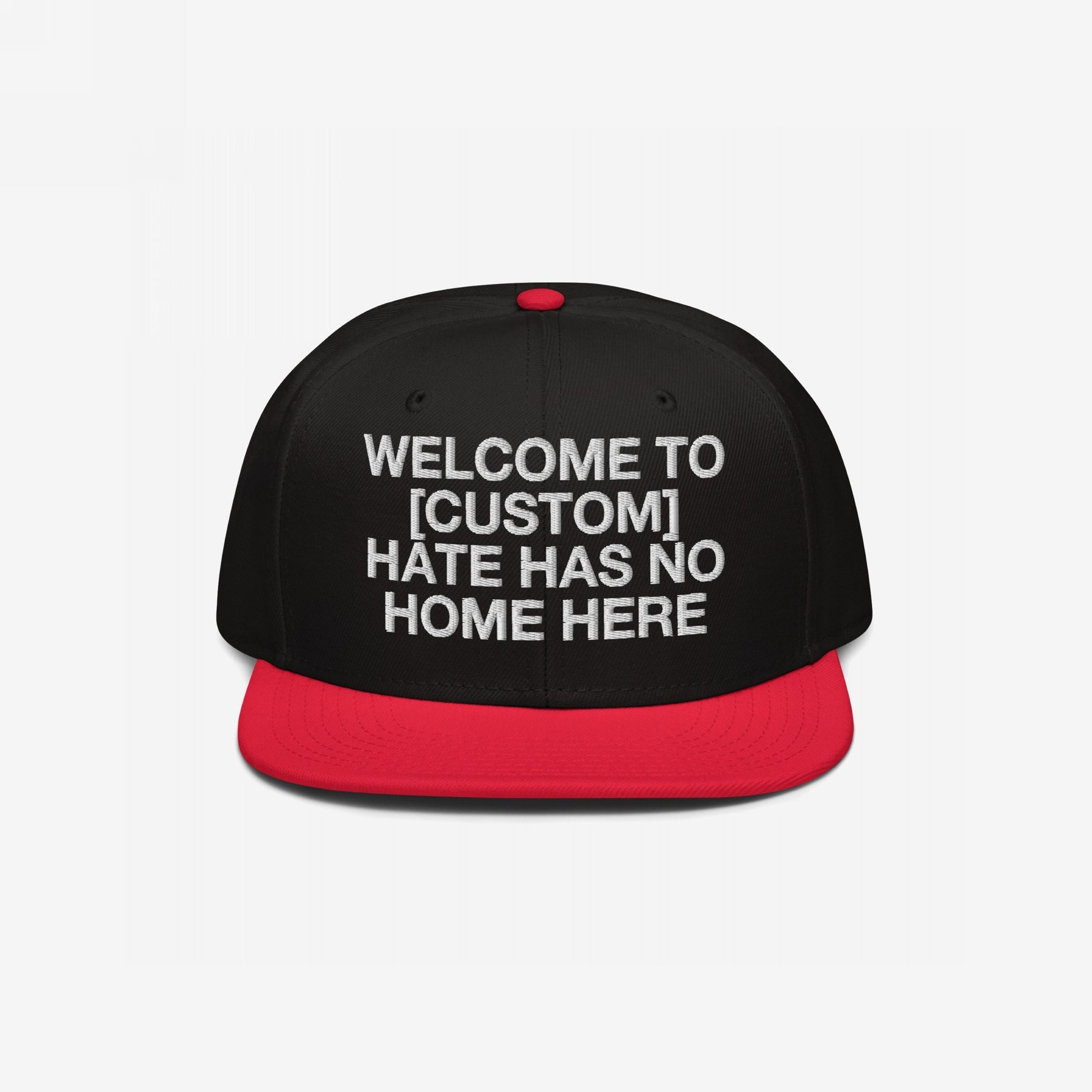 Custom Hate Has No Home Here Snapback Hat with black crown, red flat bill, and bold white embroidery promoting inclusivity and respect.