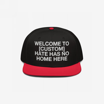 Custom Hate Has No Home Here Snapback Hat with black crown, red flat bill, and bold white embroidery promoting inclusivity and respect.