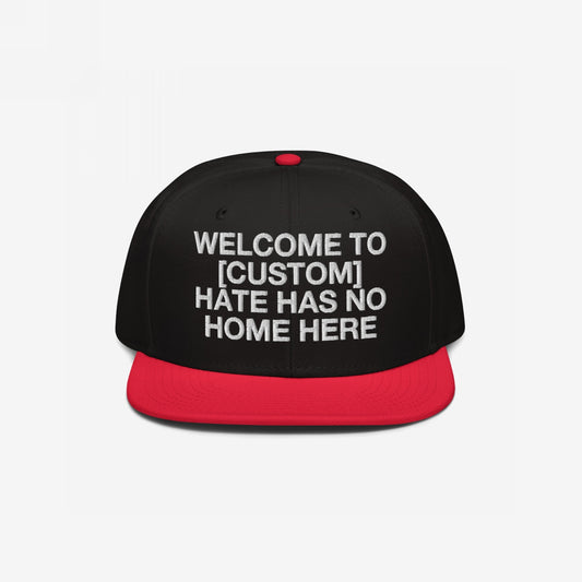 Custom Hate Has No Home Here Snapback Hat with black crown, red flat bill, and bold white embroidery promoting inclusivity and respect.