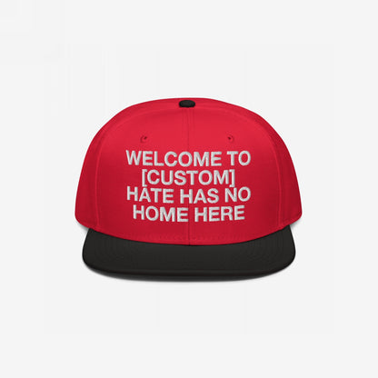 Custom Hate Has No Home Here Snapback Hat in red with black bill featuring bold embroidered customizable welcome message