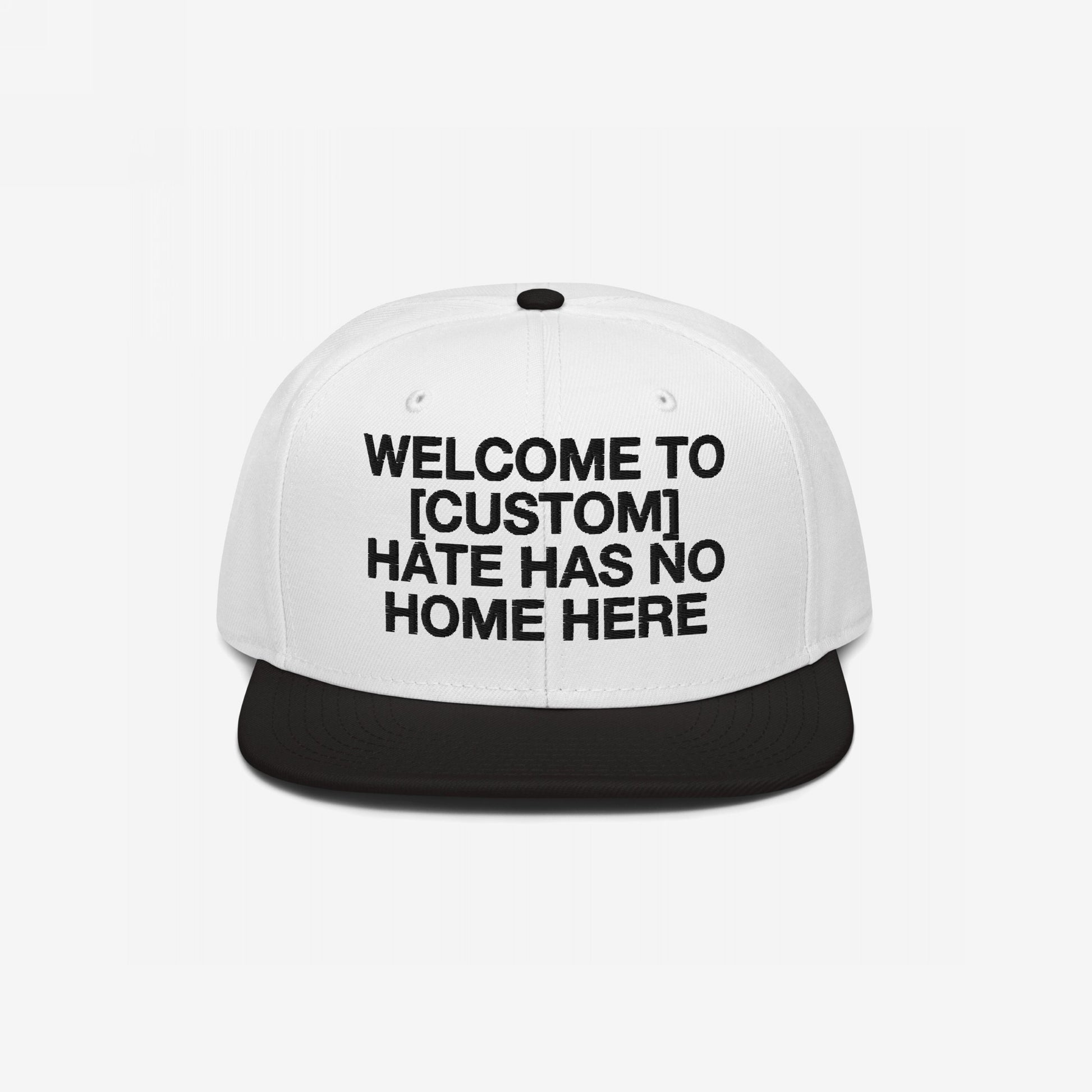 Custom Hate Has No Home Here Snapback Hat in white and black with bold embroidery promoting inclusivity and adjustable fit