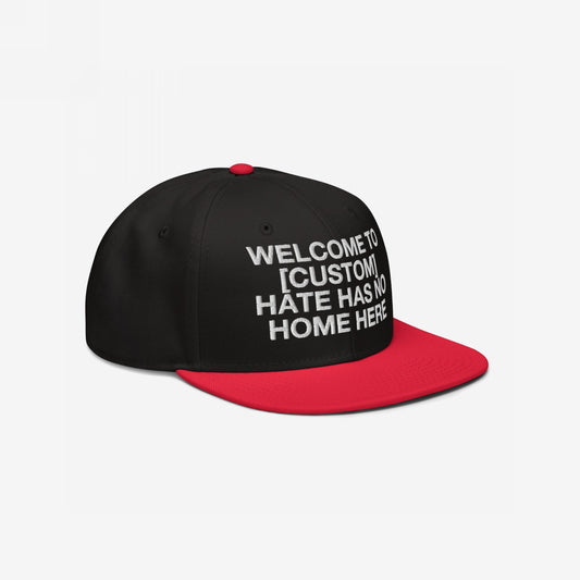 Custom Hate Has No Home Here Snapback Hat in black with red flat bill featuring bold white embroidery and adjustable snap closure.