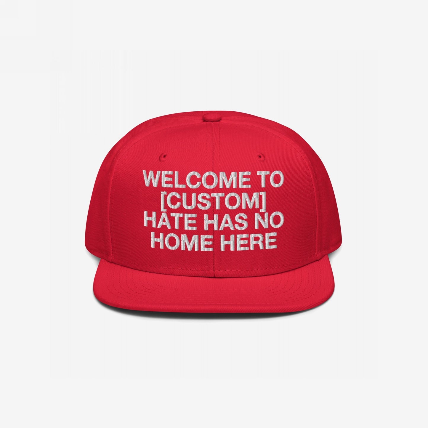 Custom Hate Has No Home Here Snapback Hat in red with bold white embroidery and flat bill, promoting inclusivity and customizable text.