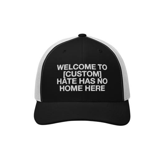 Custom Hate Has No Home Here Trucker Hat in black with white mesh back featuring customizable bold message on front panel