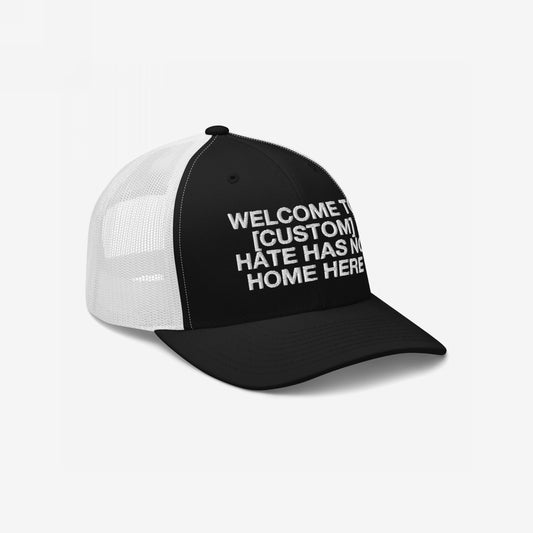 Custom Hate Has No Home Here Trucker Hat with breathable mesh back and adjustable snap closure featuring the message Welcome to [Custom].