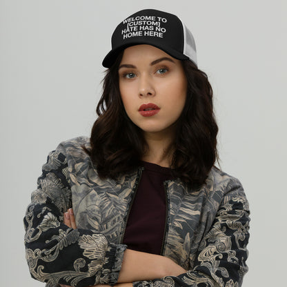 Woman wearing a Custom Hate Has No Home Here Trucker Hat with mesh back and adjustable snap closure in a bold message design